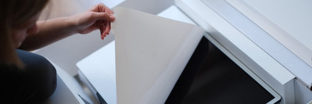 Woman hands unpacking box with modern personal computerの写真素材