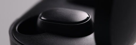 Black electronic headphones and technical cases on grey background