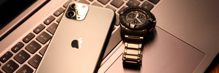 Tbilisi, Georgia - July 26, 2022: Modern smartphone apple watch on laptop keyboard.のeditorial素材