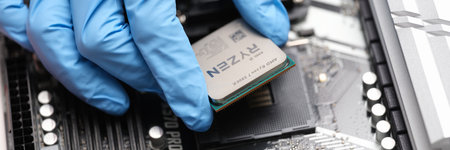 Tbilisi, Georgia - July 26, 2022: Installation of third generation Ryzen processor on motherboardのeditorial素材