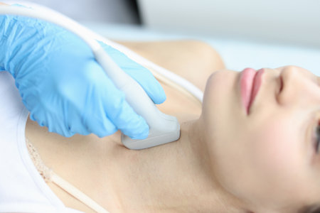 Scanning the thyroid gland of woman in medical clinic closeup