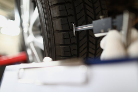 Visiting tire shop and assessing car tire damageの写真素材