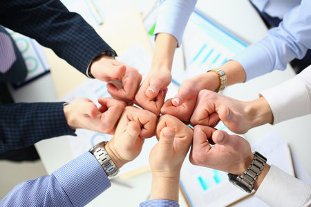 Business people holding together many thumbs upの写真素材