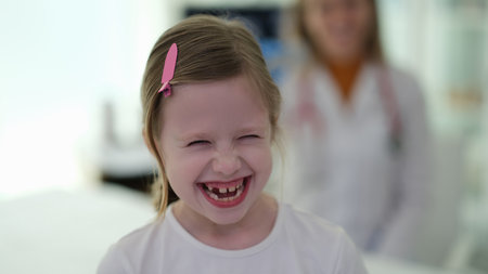 Little funny girl laughing at doctor appointment at clinicの写真素材