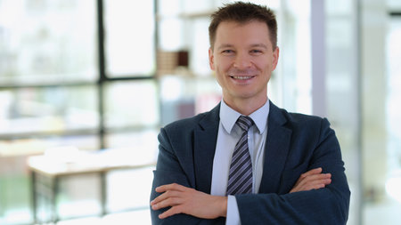 Portrait of smiling successful businessman with arms crossedの写真素材
