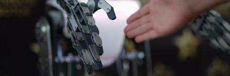 Businessman hand shaking hands with robot droid