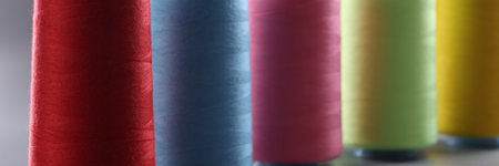 Multicolored thread spools on gray background. Set of colored threads