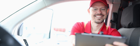 Courier is engaged in logistics of delivery and holds tabletの写真素材