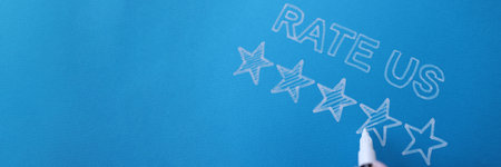 Handwritten review rate us and star rating on blue background