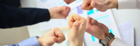 Closeup of business people hands showing thumbs up top viewの写真素材