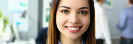Portrait of beautiful joyful emotionally happy businesswoman in background of business colleagueの写真素材