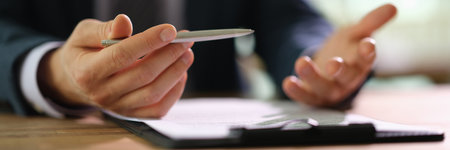 Male manager studying document contract and surprisingの写真素材