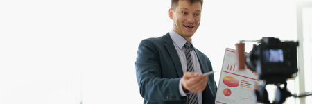 Freelancer business coach showing graphs to camera on video conferenceの写真素材