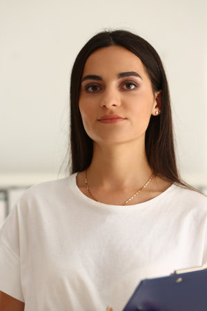 Young manager woman holding clipboard vertical photoの写真素材