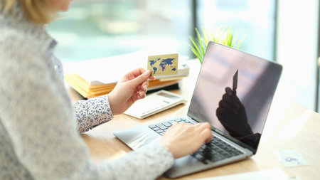 Woman shopping online and using laptopの写真素材