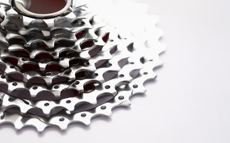 Close-up of metal gearwheel on light background. Detail from bicycle pedalの写真素材