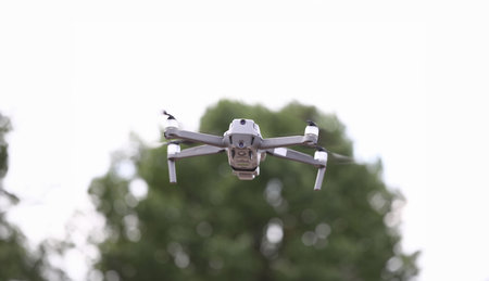 Close-up of modern quadrocopter flying in sky.の写真素材