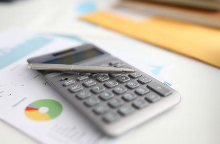 Calculator, pen and document lay on table.の写真素材