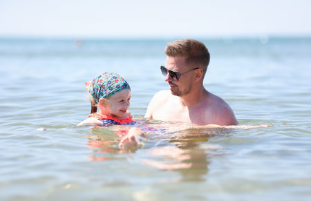 Dad and daughter are resting at sea