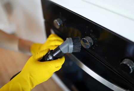 Worker dusting stoveの写真素材