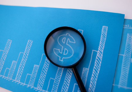Drawn financial growth chart with magnifying glass closeupの写真素材