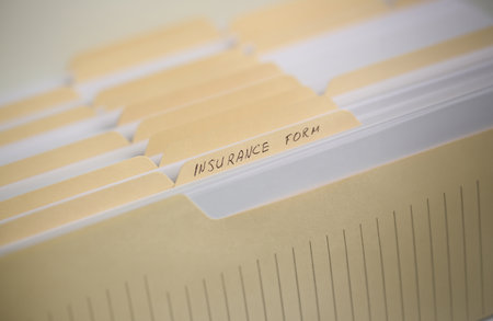 A stack of papers in filing cabinet with inscriptionの写真素材