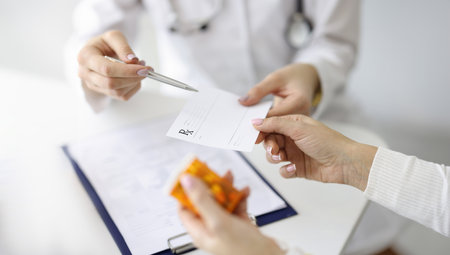 Doctor giving patient paper prescription for medicine closeupの写真素材