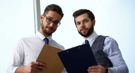 Group of modern businesspeople in office debate on financial issue