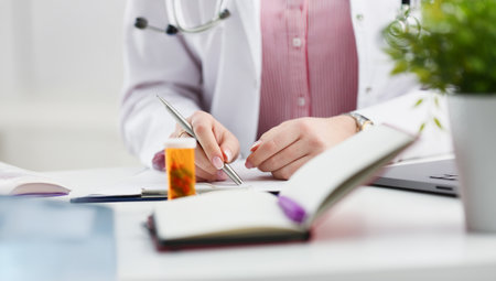Female medicine doctor hand hold jar of pillsの写真素材