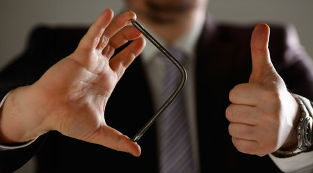 Man in suit and tie bend nail with arms closeup