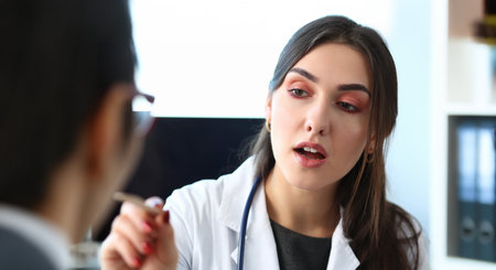 Beautiful smiling female doctor talk with patientの写真素材