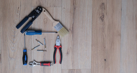 A set of tools for home repair lies on the floor, close-upの写真素材