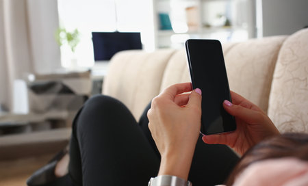 Female laying on couch with smartphone black screen