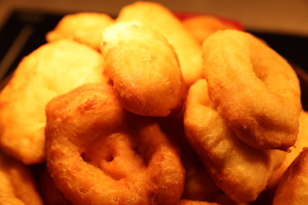 These Delicious Golden Fried Doughnuts are Stacked High for Everyone to Enjoy Themの写真素材