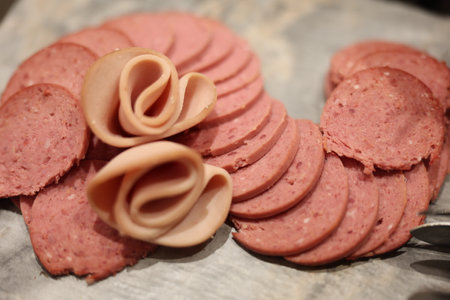 Sliced Deli Meats Beautifully Arranged in an Elegant Manner on a Decorative Platter