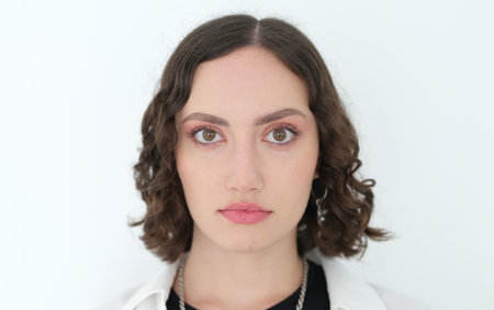 A captivating portrait of a Young Woman with curly hair against a clean white background