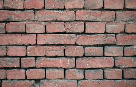A beautifully textured red brick wall background ideal for various design applicationsの写真素材