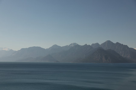 A Serene Mountain Landscape Stretching Over Tranquil and Calm Waters with Beautyの写真素材