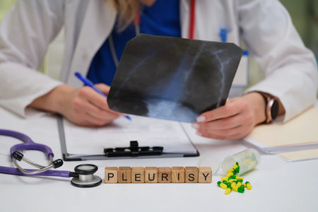 A medical doctor is carefully analyzing a chest Xray image to determine a diagnosis for pleurisyの写真素材