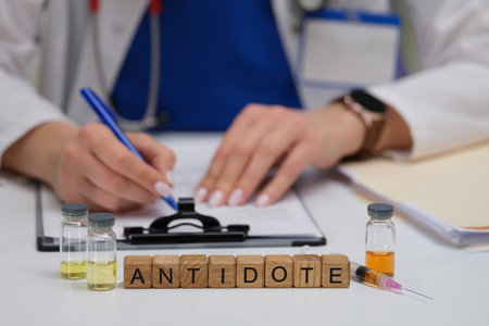 A qualified medical professional is writing a prescription for essential antidote vialsの写真素材