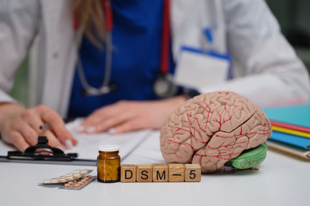 A desk of a Mental Health Professional with a Brain Model and DSM5 Diagnostic Manualの写真素材