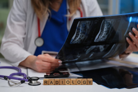 A radiologist is meticulously examining Xray images within a professional medical settingの写真素材