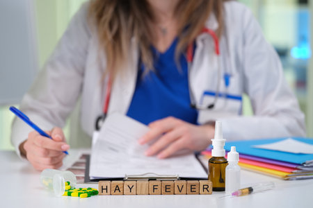 A doctor prescribes treatment for hay fever symptoms like sneezing and congestionの写真素材