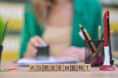 Professional Agreement Displayed on a Desk Surrounded by Notepad and Other Stationery Itemsの写真素材