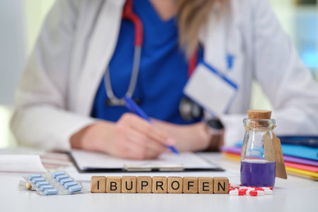 A Medical Professional with Ibuprofen and a Prescription Pad available for patient careの写真素材