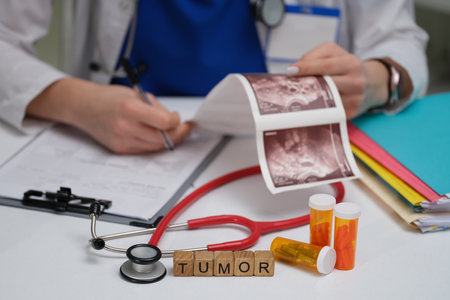 A doctor evaluates tumor images and medication in a clinical setting for optimal assessmentの写真素材