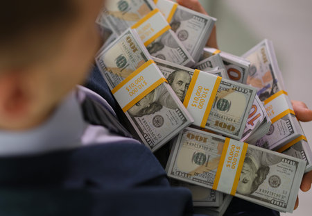 Person holds a large stack of cash in their arms, showcasing wealth and abundance in a sleek...