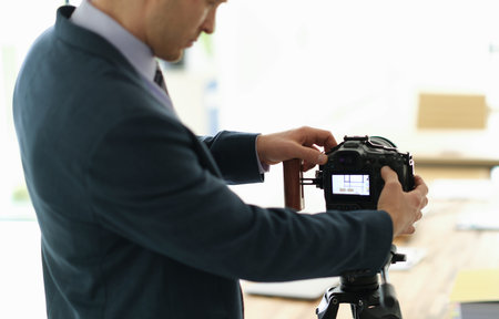 Setting up a professional camera for a creative photoshoot in a bright, modern studio setting during the dayの写真素材