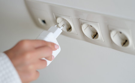 Connecting a charger to a power outlet in a bright and modern room during a productive day