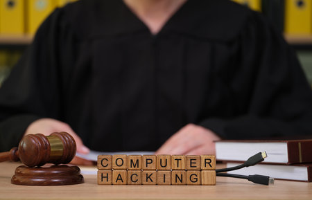 Courtroom scene showcases judge addressing computer hacking case amid legal documents and wooden...